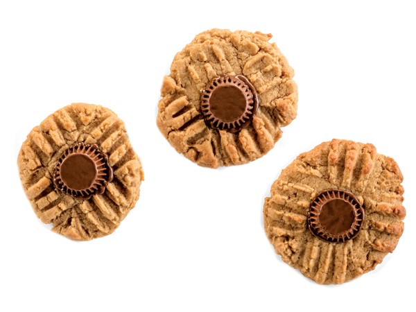 Three peanut butter cookies topped with a mini Reese's peanut butter cup