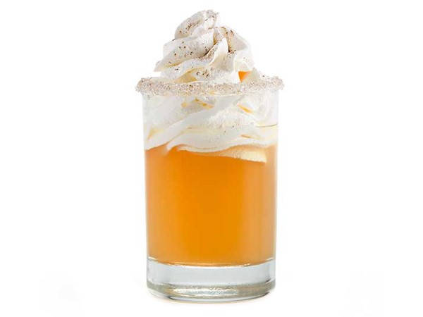 Sugar-rimmed glass of apple pie shooter garnished with whipped topping