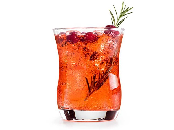Glass of cranberry spritzer garnished with rosemary and cranberries