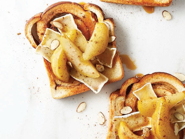 Cinnamon raisin bread topped with brie, poached pears, and sliced almonds
