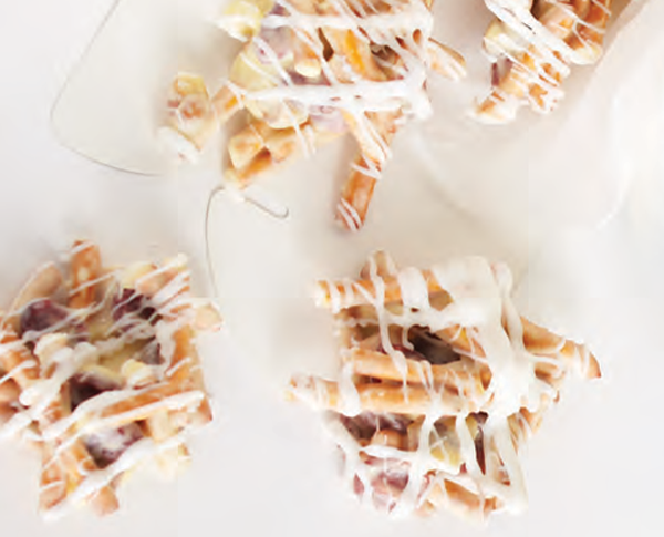 Cranberry pretzel candy clusters drizzled in white chocolate