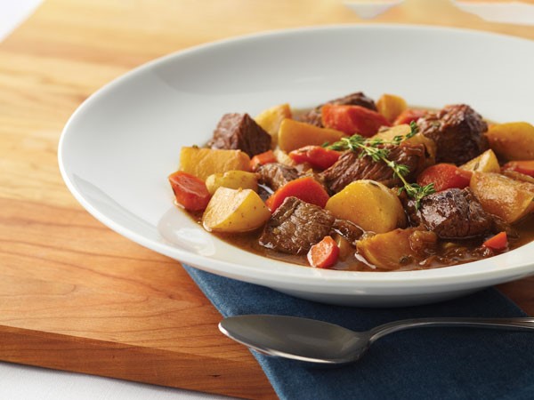 Bowl of beef stew mixed with carrots and potatoes