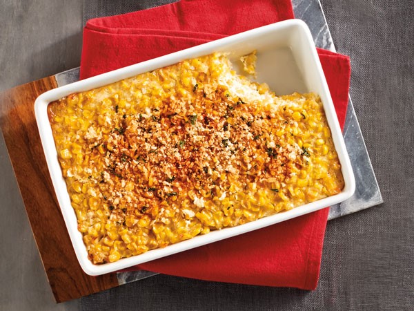 Dish of corn casserole with a slice cut out