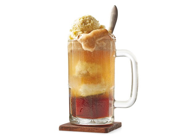 Mug of cherry cola float with a spoon