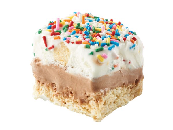 Rice krispy bar topped with chocolate icing, cake & ice cream and colored sprinkles