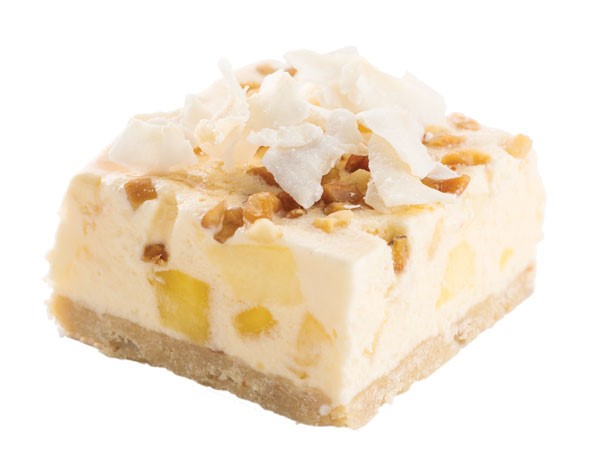 Pina colada bars topped with fresh coconut flakes