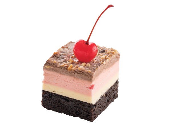 Brownie square layered with vanilla ice cream, strawberries & cream ice cream, chocolate ice cream, sweet and salty nut ice cream topping and a maraschino cherry