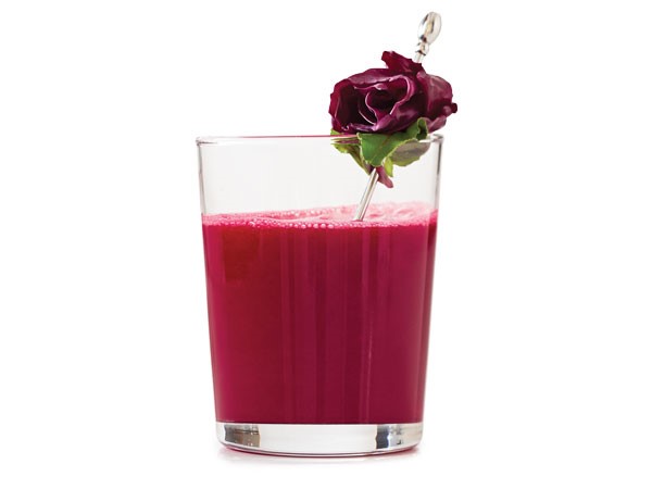 Purple juice in glass garnished with fresh cabbage