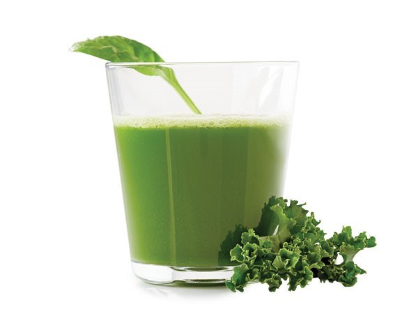 Glass of clean green, garnished with a spinach leaf