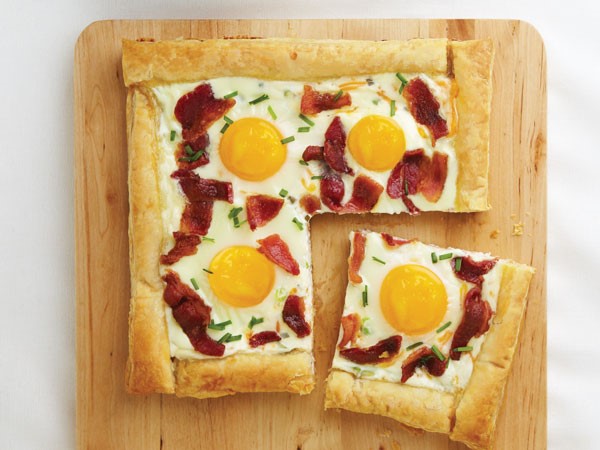 Bacon and egg tart served on a wooden board