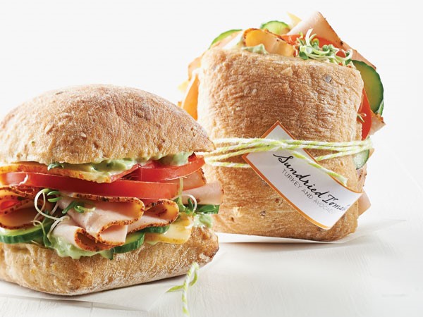 Ciabatta rolls filled with sundried tomato, turkey, avocado, tomatoes and cucumbers