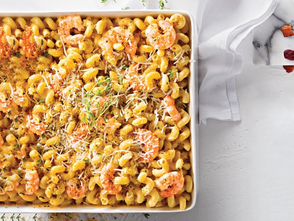 Macaroni and cheese dish topped with shrimp, panko bread crumbs, shredded parmesan and fresh thyme