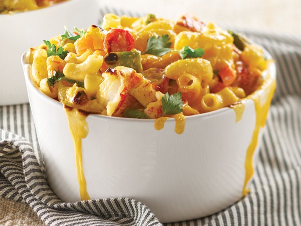 Cups of macaroni and cheese combined with lobster meat, tomatoes and parsley