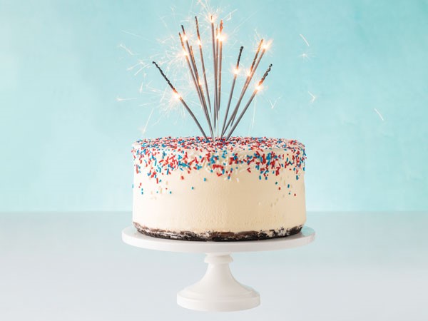 Vanilla ice cream cake topped with red, white and blue sprinkles and garnished with sparklers