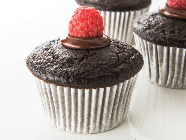 Muffin tins filled with chocolate-raspberry snack cakes