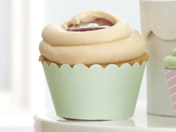 Peanut butter cupcake topped with frosting and jelly