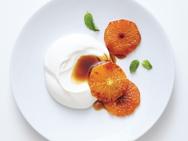 Plate of carmelized oranges with side of cream