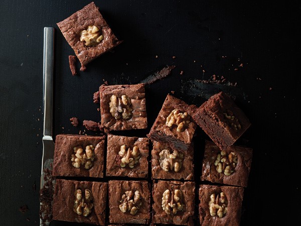 Chocolate walnut brownie squares garnished with a walnut