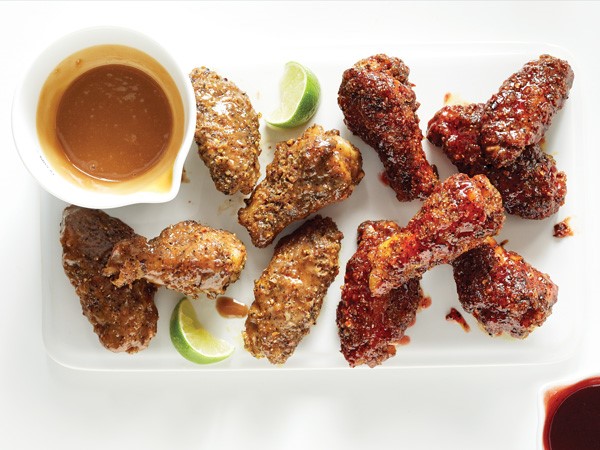 Peanut butter and jelly sticky wings on platter with dipping sauces