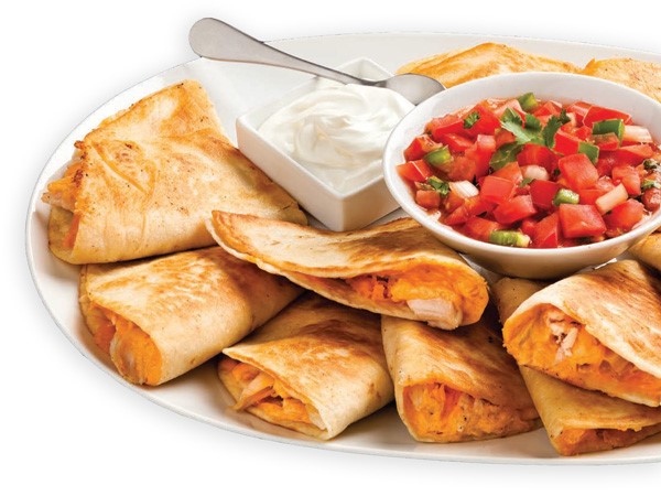 Quesadillas filled with chicken, cheese, and buffalo sauce on a white plate with sides of sour cream and pico de gallo