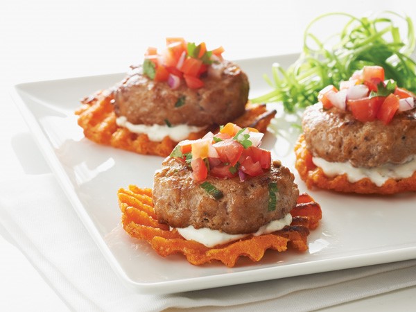 Plate of Cajun burger bites on sweet potato waffle fries