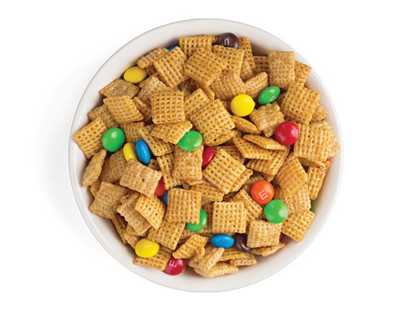 Bowl of caramel crispy chex mix combined with M&M candies