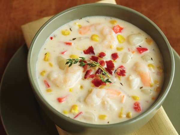 Bowl of Corn and Shrimp Chowder, garnished with Bacon Bits