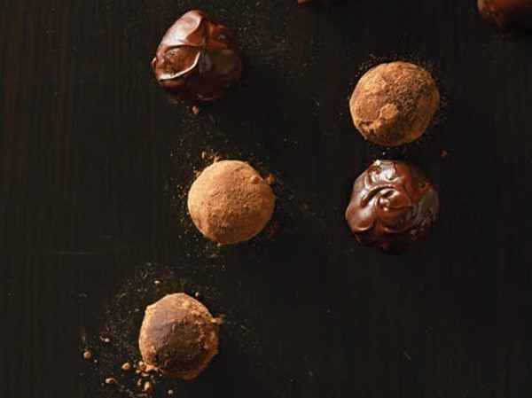 Chocolate bourbon balls dusted with cocoa powder