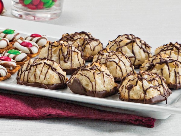 Coconut macarnoons partially dipped and drizzled in melted chocolate