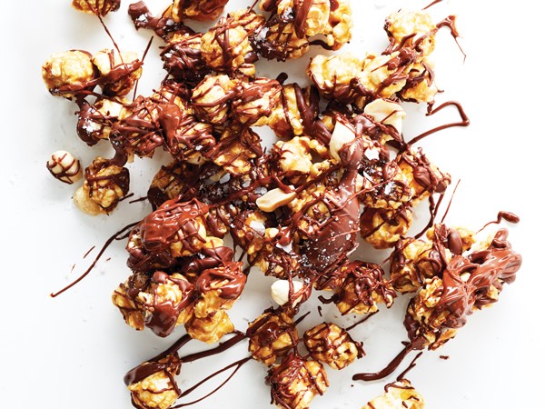 Chocolate-drizzled caramel corn on parchment paper