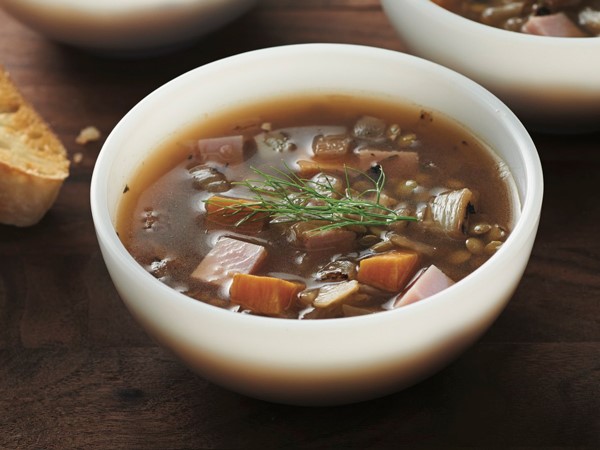 White bowls filled with smoked ham and lentil soup