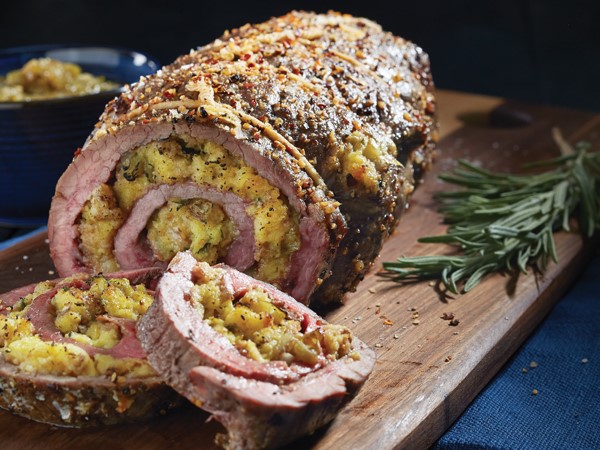 Flank steak stuffed with spicy stuffing and served with a side of salsa verde