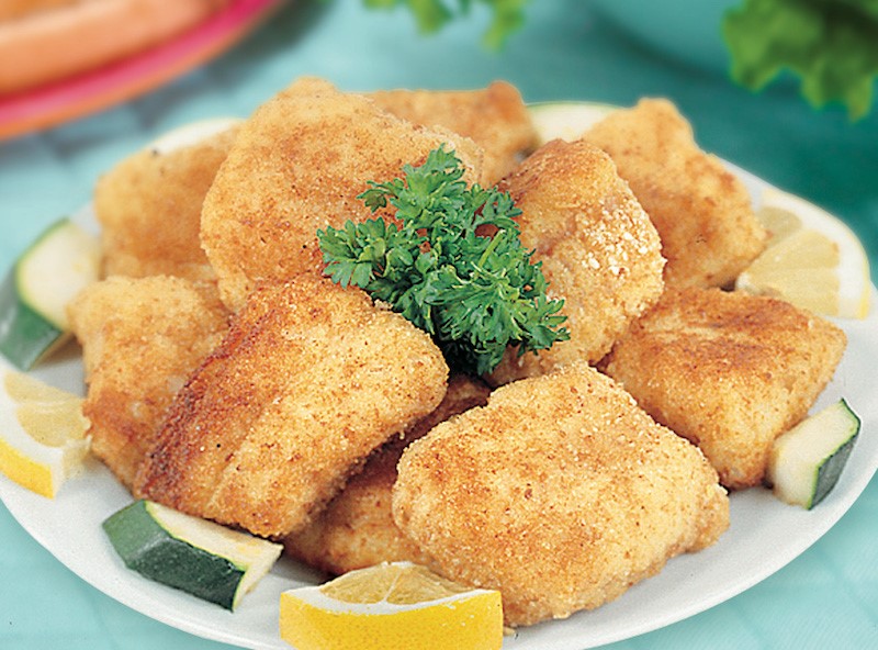Pile of catfish nuggets on a white plate