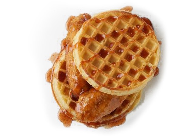 Chicken tenders sandwiched between two waffles and topped with syrup