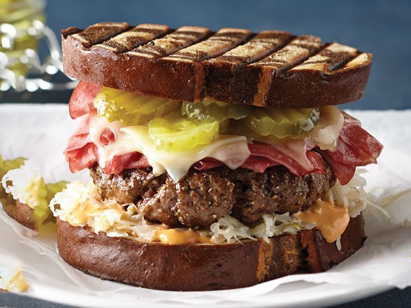 Grilled marble bread with coleslaw, thousand island dressing, burger patty, melted Swiss and pickles