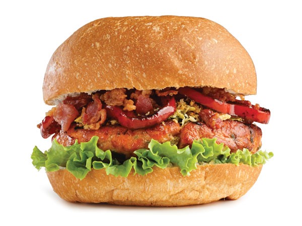 Salmon patty with lettuce, panko mixture, grilled red pepper and bacon sandwiched between a bun