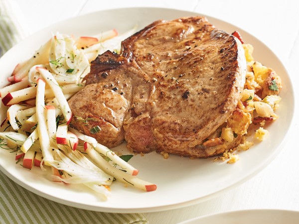 Plate of baked pork chops stuffed with apple corn bread