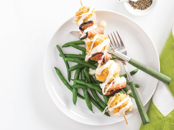 Breaded ham and cheese skewers over green beans
