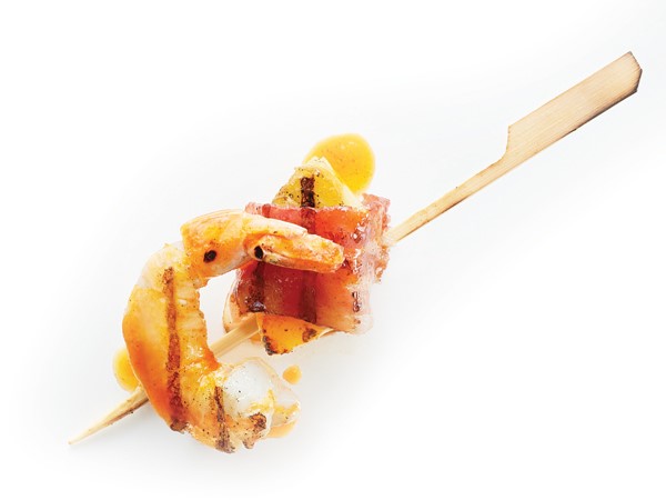 Bacon-wrapped shrimp and pineapple on a wooden skewer