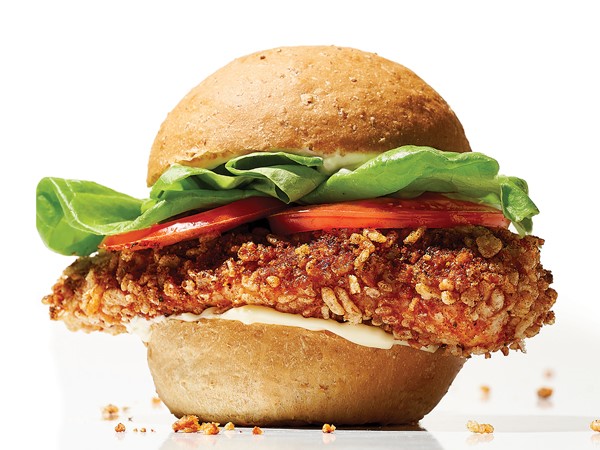 Spicy breaded chicken sandwich with lettuce and tomatoes on bun