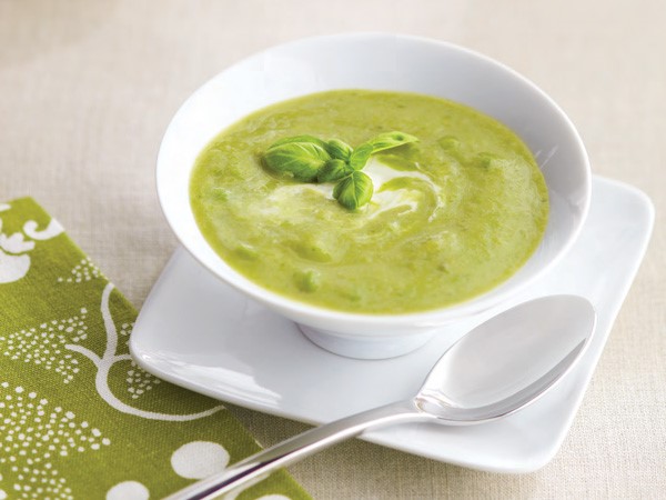 Bowl of Creamy Asparagus Soup garnished with Sour Cream and Basil