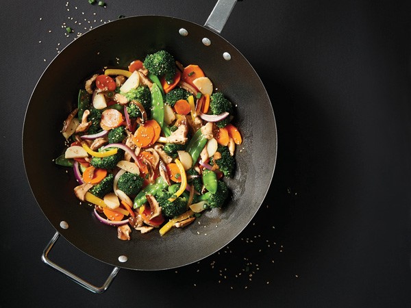 Skillet filled with vegetable stir-fry topped with sesame seeds