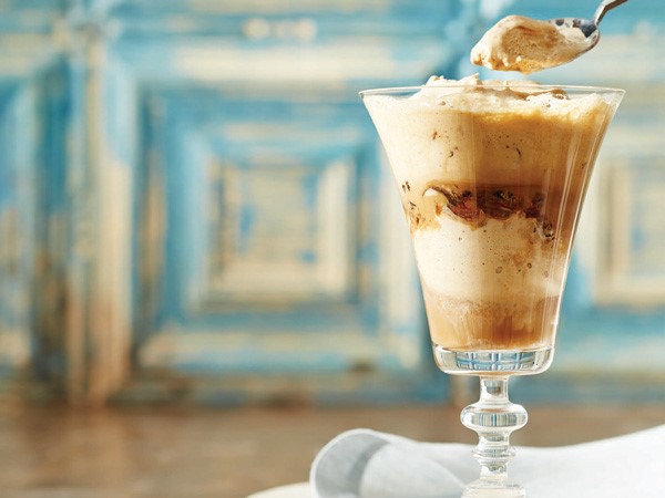 Glass and spoon of cappuccino frappe