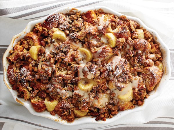 White casserole dish filled with banana streusel croissant bread pudding
