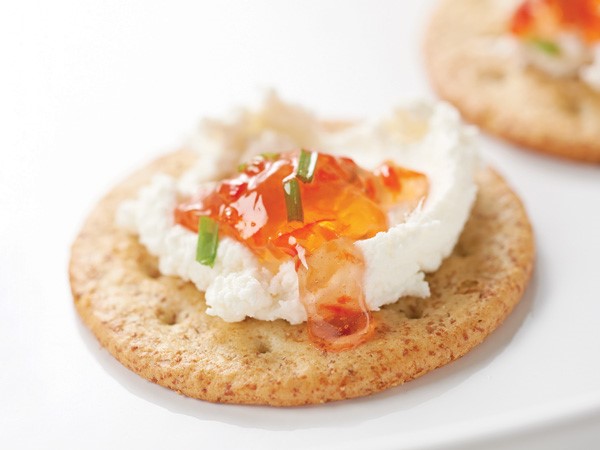 Red pepper jelly and cheese on a cracker