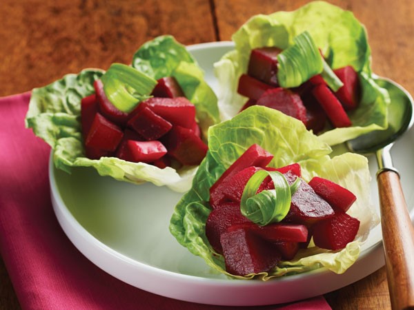 Pickled beet salad in lettuce wraps on white platter