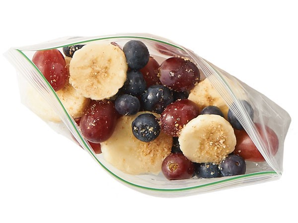 Grapes, blueberries and sliced bananas in a plastic baggie