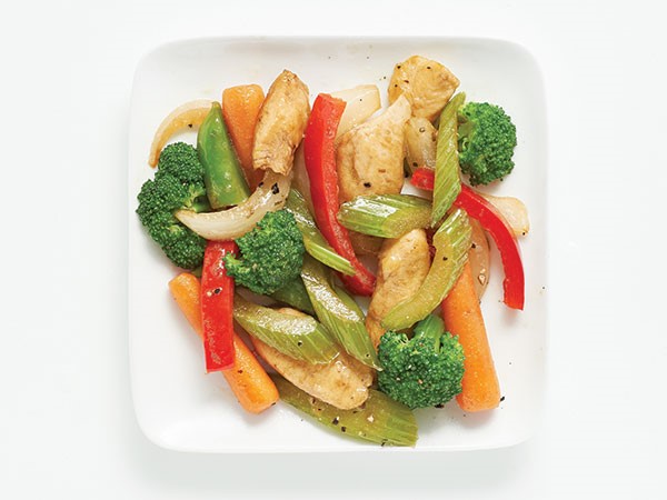 Plate filled with vegetable stir-fry topped with sesame seeds