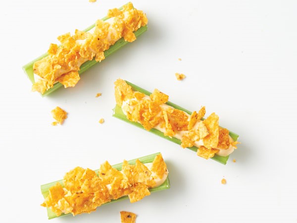 Celery sticks filled with cheesy cream cheese filling and topped with crushed nacho cheese chips