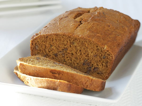 Sliced banana bread on white platter